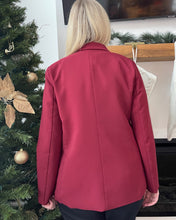 Load image into Gallery viewer, Person wearing a red blazer standing in front of a decorated Christmas tree.
