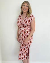 Load image into Gallery viewer, Woman wearing a rust, mauve and white patterned dress against a white background
