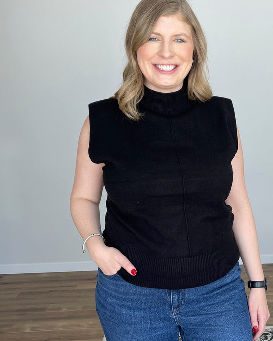 woman in a black mock neck tank with structured shoulders