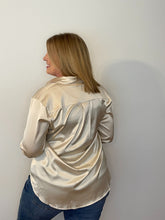 Load image into Gallery viewer, Back of woman wearing champagne color satin button-down shirt with a middle pleat on the back
